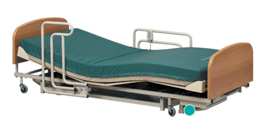 a hospital bed with a green sheet on it.