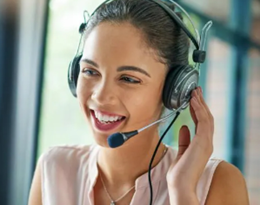 A woman wearing a headset and smiling.